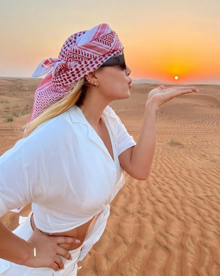 Guest balancing the rising sun on her palm – Al Khatim dunes, Abu Dhabi