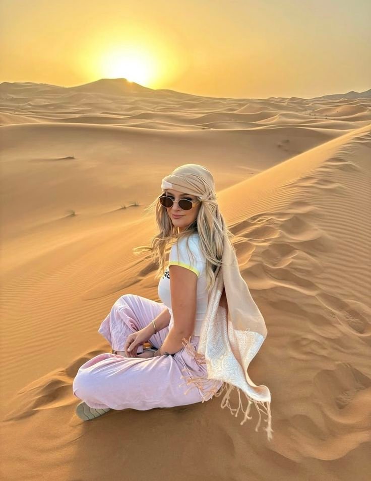 Guest relaxing on the golden Al Khatim dunes at sunset – VIP desert safari